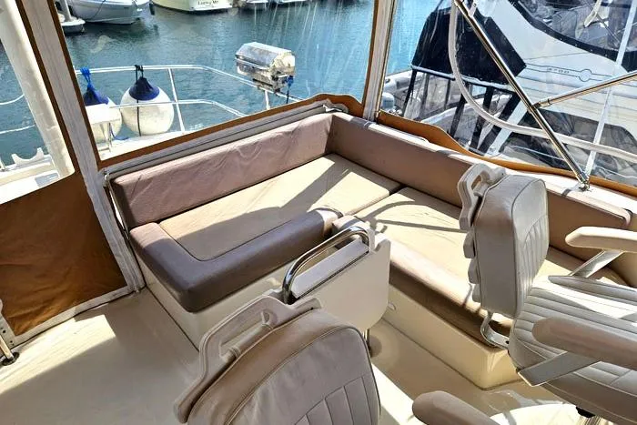  Yacht Photos Pics 2007 Mainship 34 Trawler interior with seating, docked at marina.