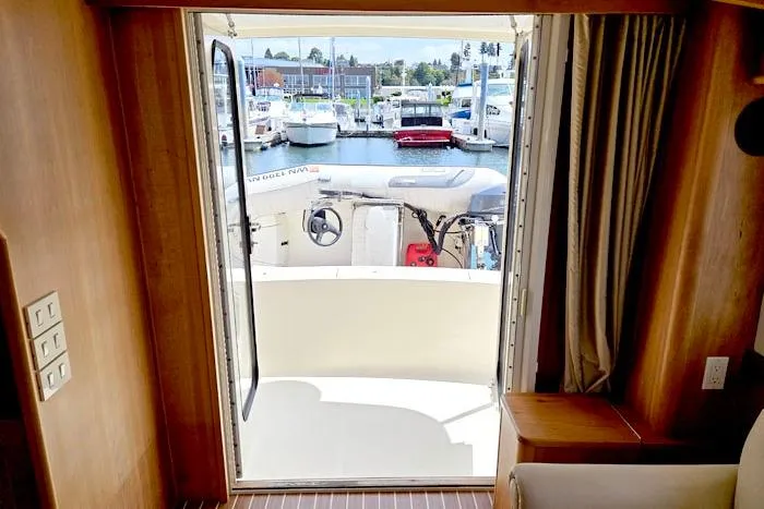  Yacht Photos Pics Interior view of 2007 Mainship 34 Trawler, looking out to marina through open door.