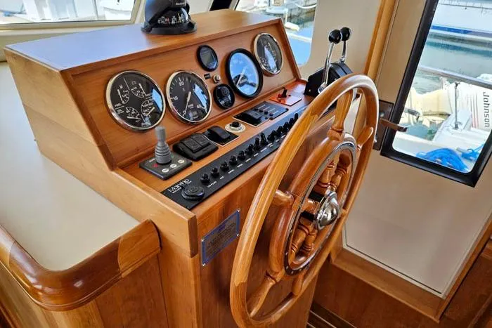  Yacht Photos Pics 2007 Mainship 34 Trawler helm with wooden wheel and instrument panel.