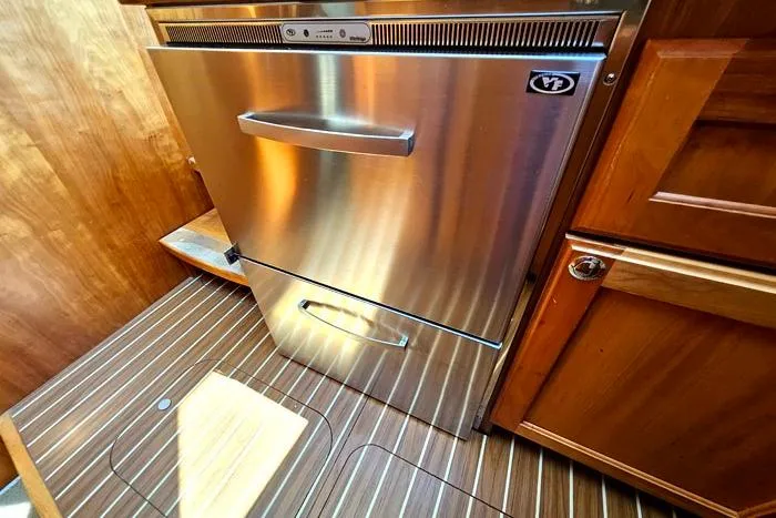  Yacht Photos Pics Stainless steel refrigerator in 2007 Mainship 34 Trawler's wooden interior kitchen.