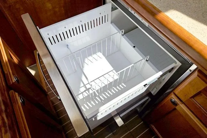  Yacht Photos Pics Open drawer in 2007 Mainship 34 Trawler kitchen, featuring organized storage space.