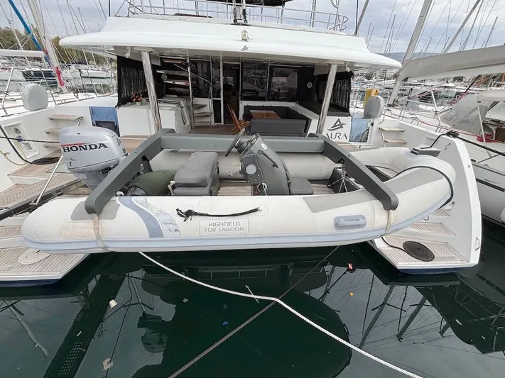Avra Yacht Photos Pics 2014 Lagoon 560 S2 yacht with inflatable dinghy and Honda outboard motor.