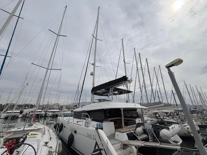 Avra Yacht Photos Pics 2014 Lagoon 560 S2 yacht docked in a marina with overcast sky.