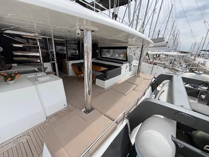 Avra Yacht Photos Pics Luxurious 2014 Lagoon 560 S2 yacht interior with seating and dining area in marina.