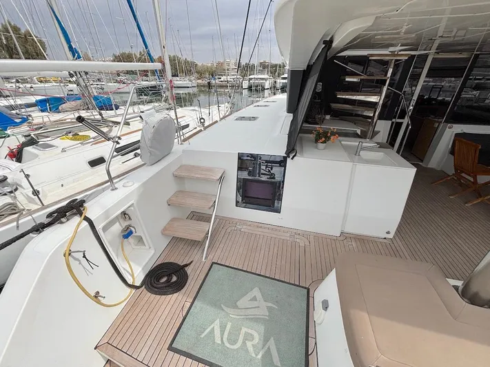 Avra Yacht Photos Pics 2014 Lagoon 560 S2 yacht deck with seating, steps, and marina view.
