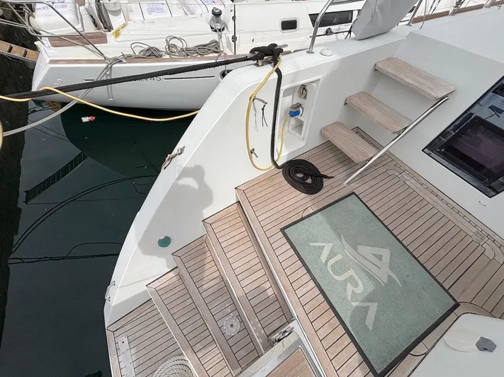 Avra Yacht Photos Pics Lagoon 560 S2 yacht deck with steps, mat, and docked at marina, 2014 model.