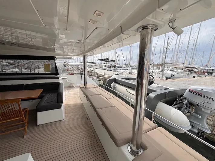 Avra Yacht Photos Pics Spacious deck of 2014 Lagoon 560 S2 yacht with seating and marina view.