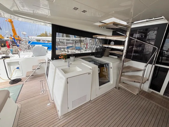 Avra Yacht Photos Pics Luxurious 2014 Lagoon 560 S2 yacht interior with modern kitchenette and wooden flooring.
