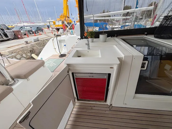 Avra Yacht Photos Pics Lagoon 560 S2 yacht deck with sink and storage, 2014 model, docked at marina.