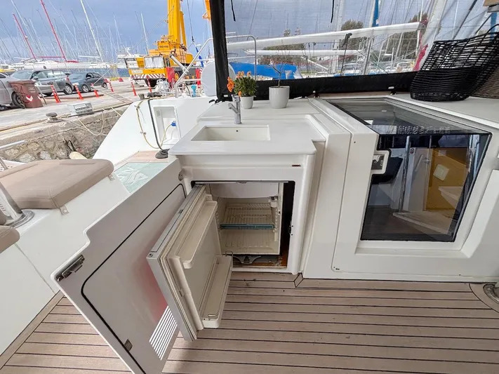 Avra Yacht Photos Pics 2014 Lagoon 560 S2 yacht deck with open fridge and sink area.