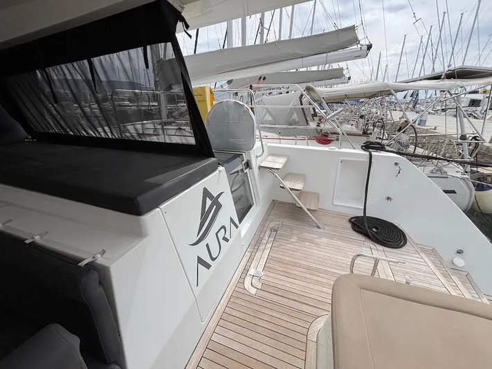 Avra Yacht Photos Pics 2014 Lagoon 560 S2 yacht deck with seating, docked at marina.