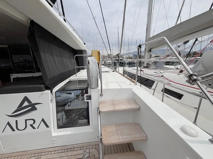Avra Yacht Photos Pics Lagoon 560 S2 yacht deck with steps, docked in a marina, 2014 model.