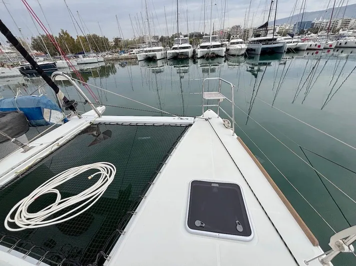 Avra Yacht Photos Pics Lagoon 560 S2 catamaran docked in marina, 2014 model, with visible deck and moored boats.