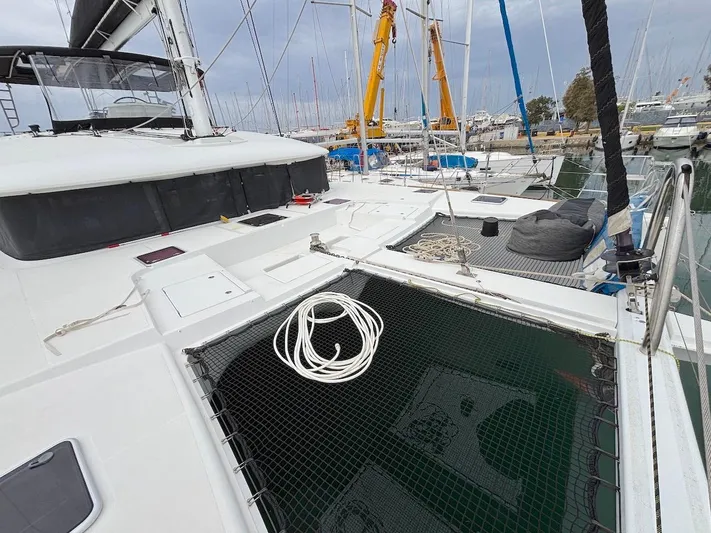 Avra Yacht Photos Pics 2014 Lagoon 560 S2 catamaran docked at marina, featuring spacious deck and netting.