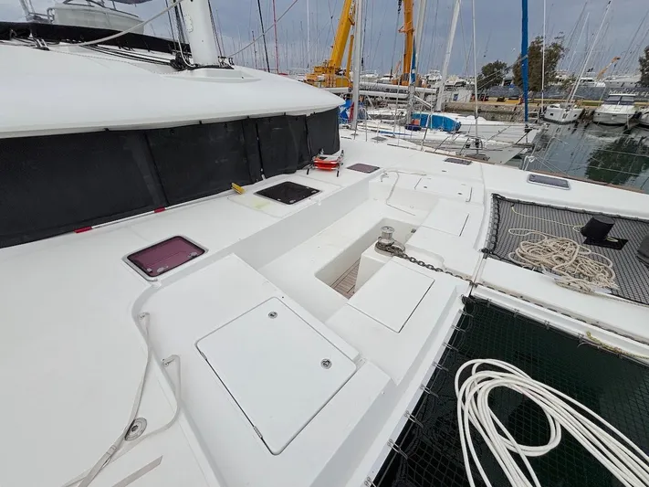 Avra Yacht Photos Pics 2014 Lagoon 560 S2 catamaran deck with storage hatches and mooring ropes in marina.