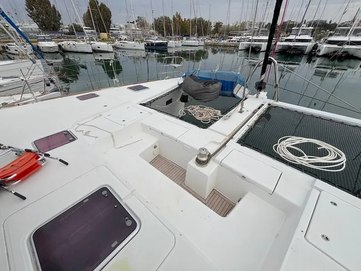 Avra Yacht Photos Pics 2014 Lagoon 560 S2 yacht deck with ropes and hatches in a marina setting.