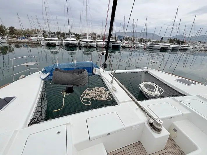 Avra Yacht Photos Pics Lagoon 560 S2 catamaran deck with ropes, docked in a marina, 2014 model.