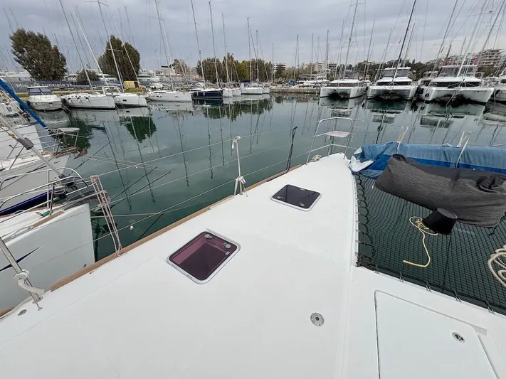 Avra Yacht Photos Pics 2014 Lagoon 560 S2 yacht docked in a marina with multiple sailboats.