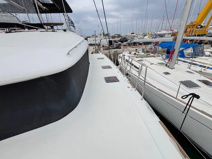 Avra Yacht Photos Pics 2014 Lagoon 560 S2 yacht docked at marina, surrounded by other boats.