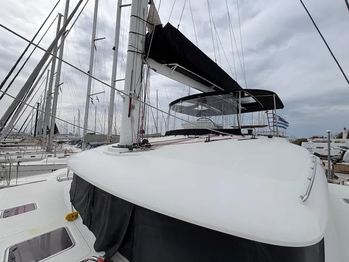 Avra Yacht Photos Pics 2014 Lagoon 560 S2 yacht with sleek design, docked in a marina under cloudy skies.