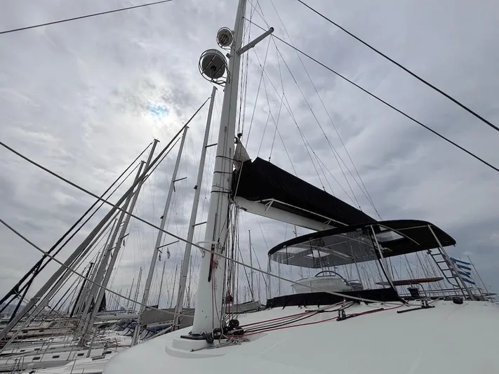 Avra Yacht Photos Pics 2014 Lagoon 560 S2 sailboat with mast and rigging against cloudy sky.