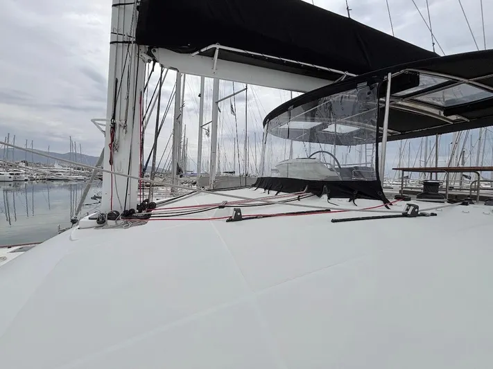 Avra Yacht Photos Pics 2014 Lagoon 560 S2 yacht deck with black canopy, docked in marina.
