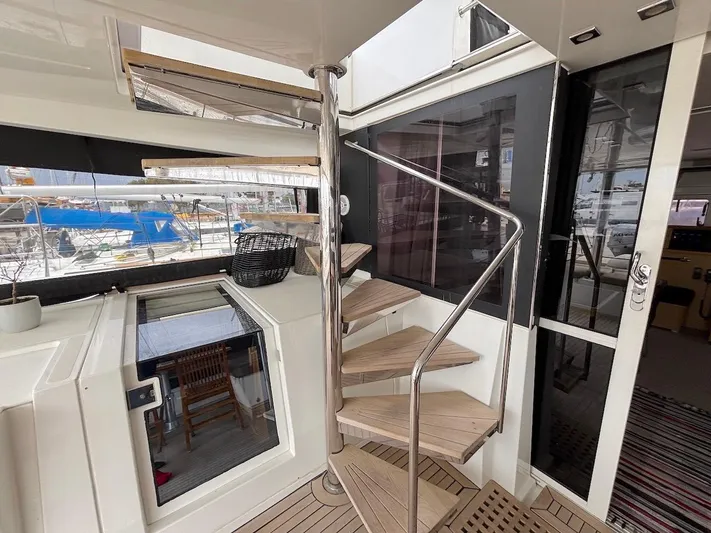 Avra Yacht Photos Pics Interior of 2014 Lagoon 560 S2 yacht with spiral staircase and modern design elements.