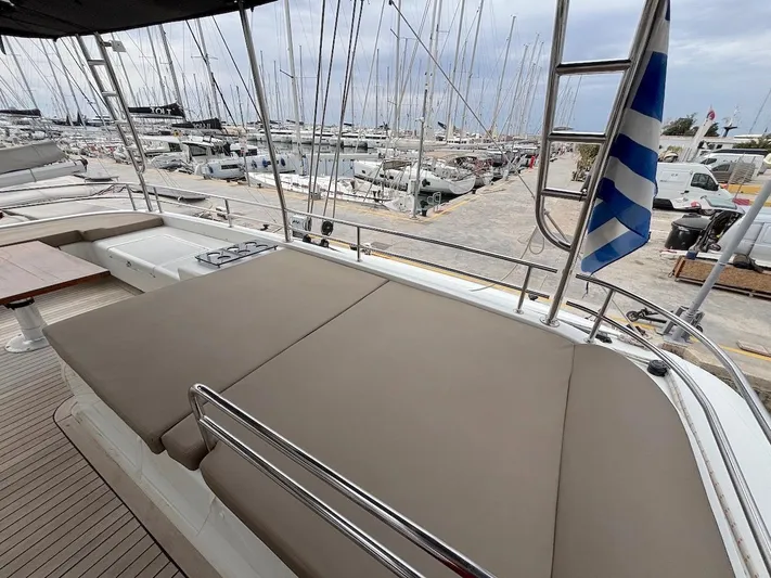 Avra Yacht Photos Pics Lagoon 560 S2 yacht deck with sunbathing area, docked at marina, 2014 model.
