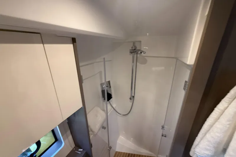  Yacht Photos Pics 2023 Beneteau Gran Turismo 45 yacht bathroom with modern shower and sleek design.