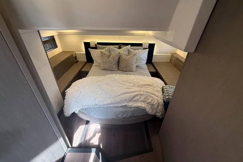  Yacht Photos Pics Luxurious bedroom interior of 2023 Beneteau Gran Turismo 45 yacht with cozy bedding.