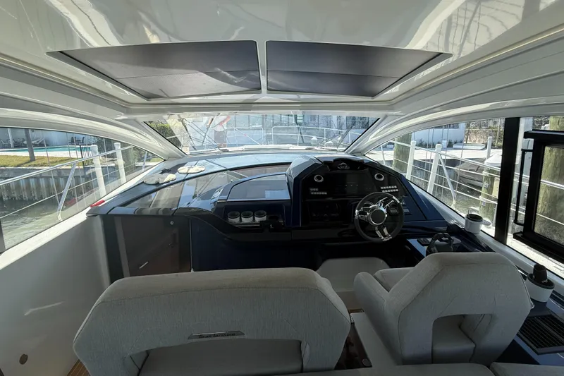  Yacht Photos Pics Interior cockpit of 2023 Beneteau Gran Turismo 45 yacht, featuring modern steering and controls.