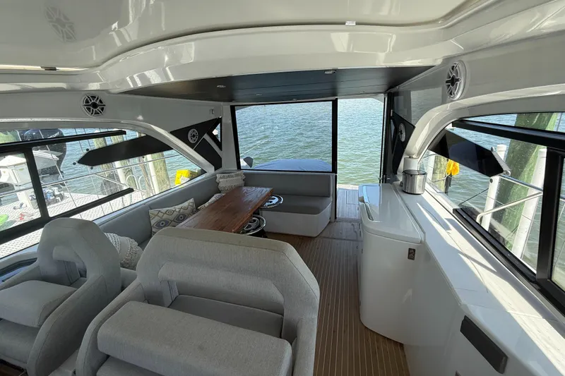  Yacht Photos Pics Interior of 2023 Beneteau Gran Turismo 45 yacht with modern seating and waterfront view.