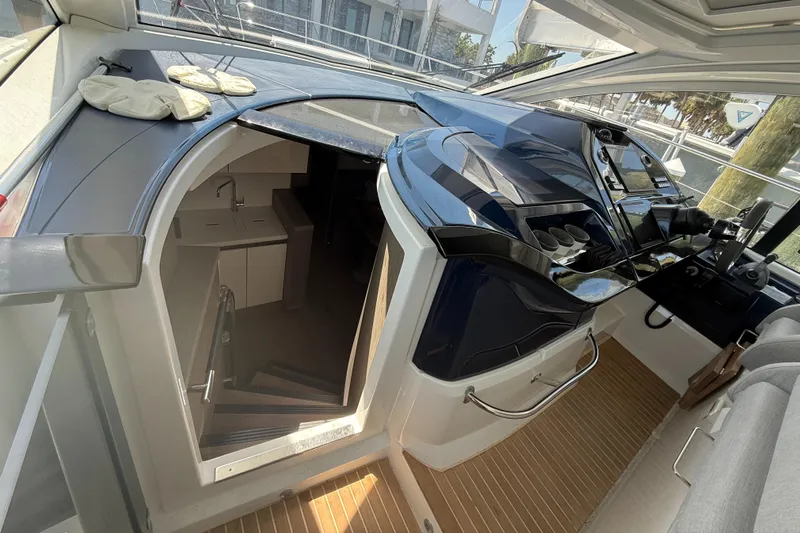  Yacht Photos Pics 2023 Beneteau Gran Turismo 45 interior with modern helm and cabin entrance.