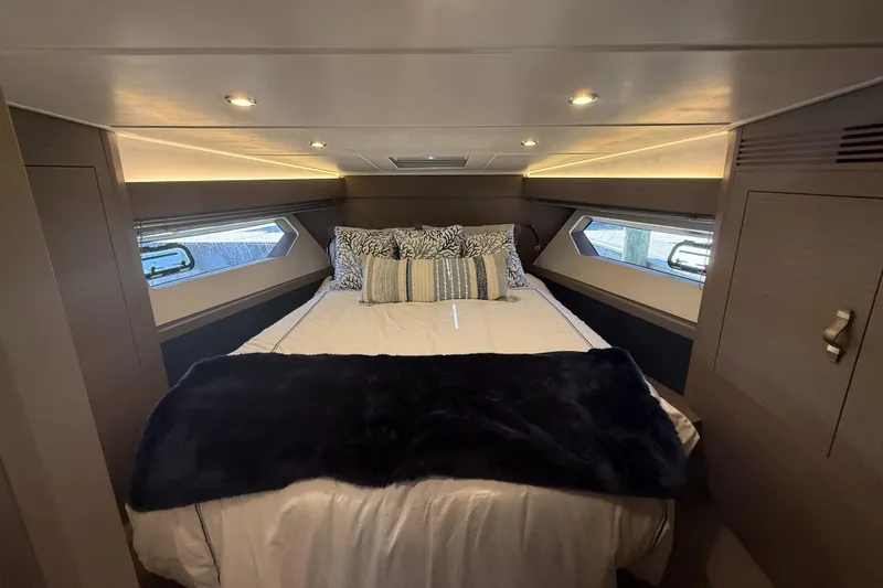  Yacht Photos Pics Luxurious cabin interior of 2023 Beneteau Gran Turismo 45 yacht with cozy bedding.