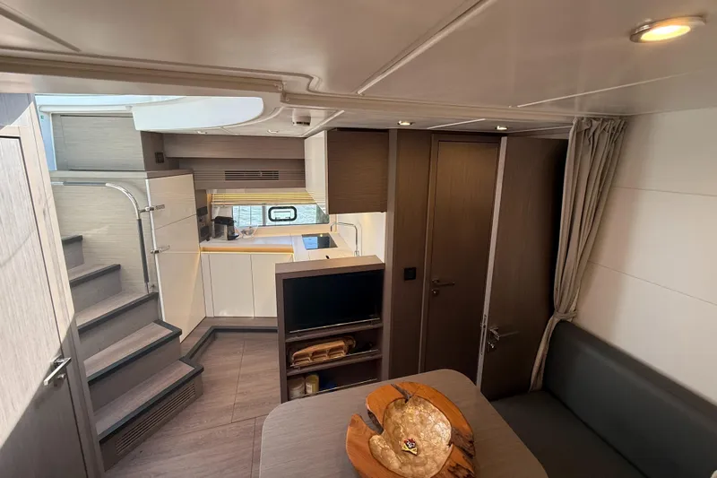  Yacht Photos Pics 2023 Beneteau Gran Turismo 45 interior with modern kitchen and cozy seating area.