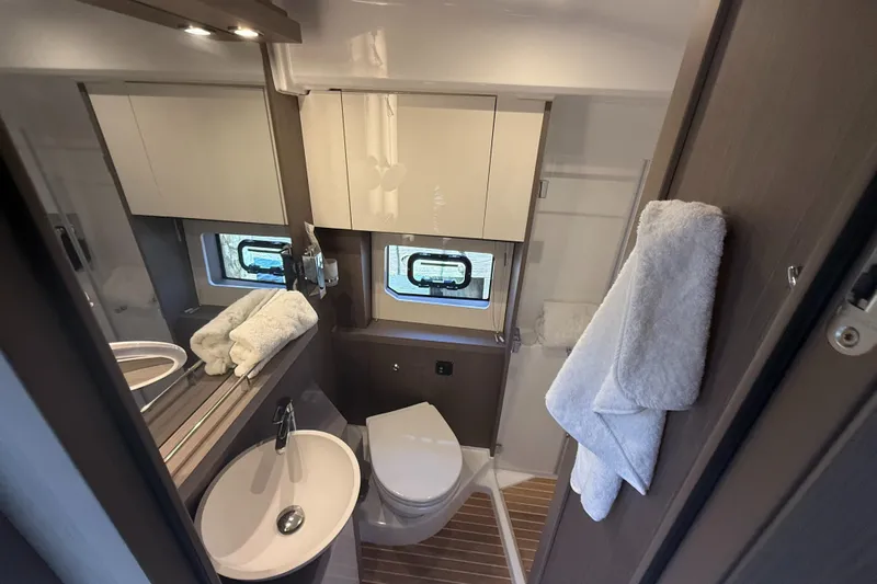  Yacht Photos Pics Modern bathroom in 2023 Beneteau Gran Turismo 45 yacht, featuring sleek design and amenities.