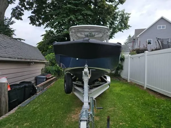  Yacht Photos Pics 2023 Yamaha Boats 275 SDX on trailer, parked in residential yard.