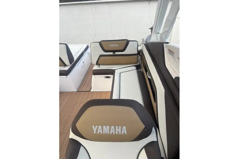  Yacht Photos Pics 2023 Yamaha Boats 275SDX interior with tan and white seating, showcasing luxury design.
