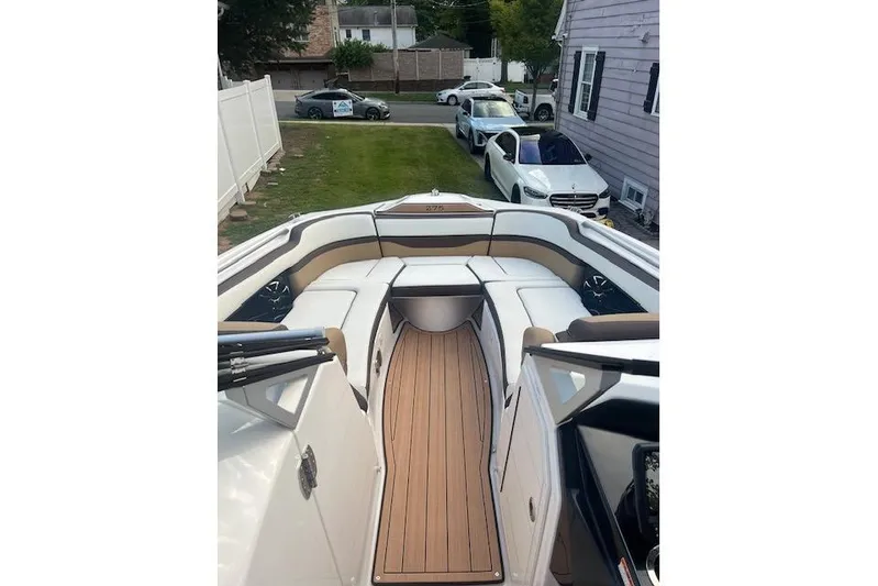  Yacht Photos Pics 2023 Yamaha Boats 275SDX interior with sleek seating and wood-style flooring.