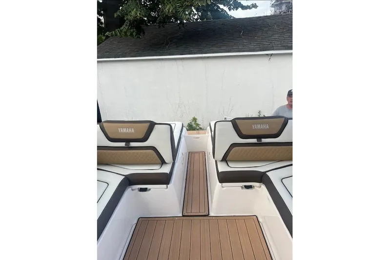  Yacht Photos Pics 2023 Yamaha Boats 275SDX interior with cushioned seating and teak-style flooring.