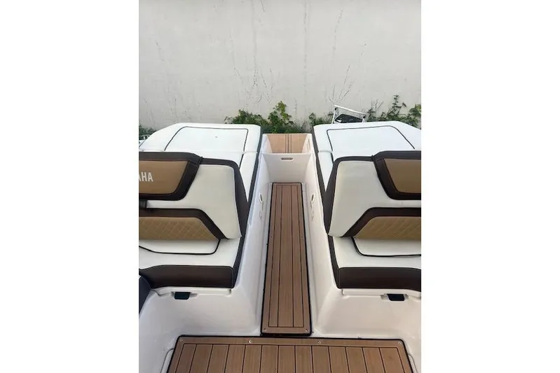  Yacht Photos Pics 2023 Yamaha Boats 275SDX interior with sleek seating and wooden flooring.