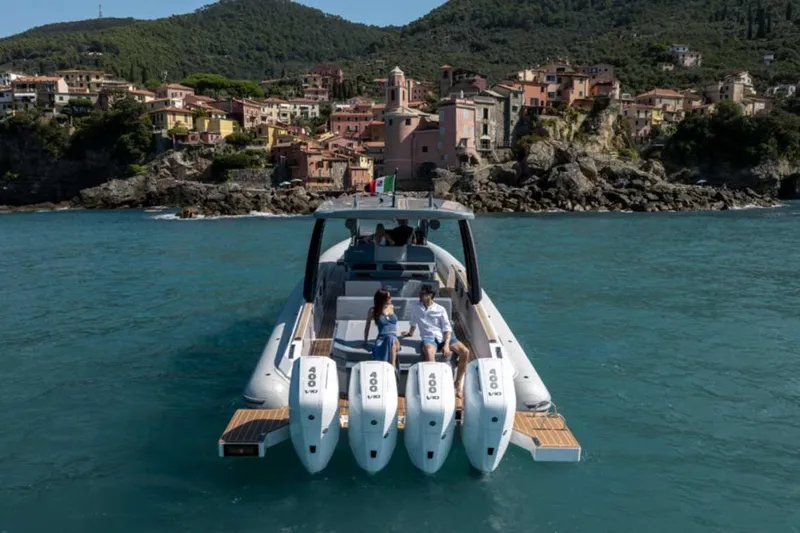  Yacht Photos Pics 2026 Ranieri CAYMAN 50 HARDTOP yacht cruising near scenic coastal village.