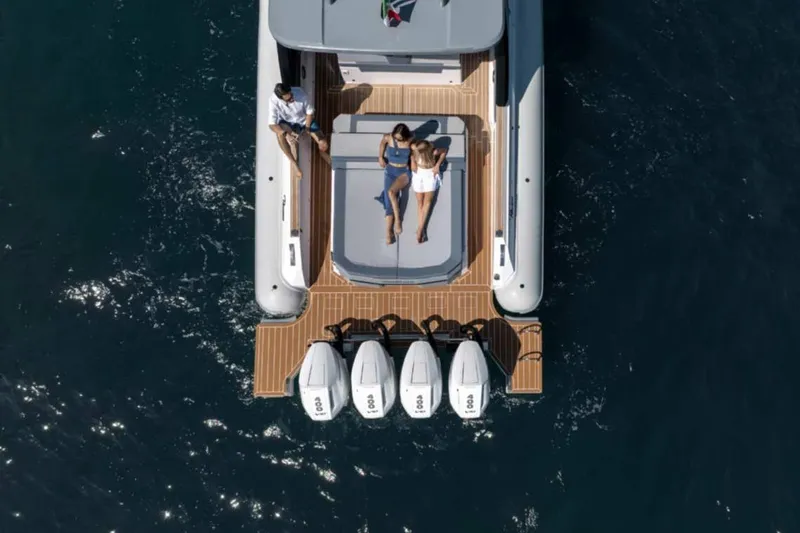  Yacht Photos Pics 2026 Ranieri CAYMAN 50 HARDTOP yacht with people relaxing on deck, aerial view.