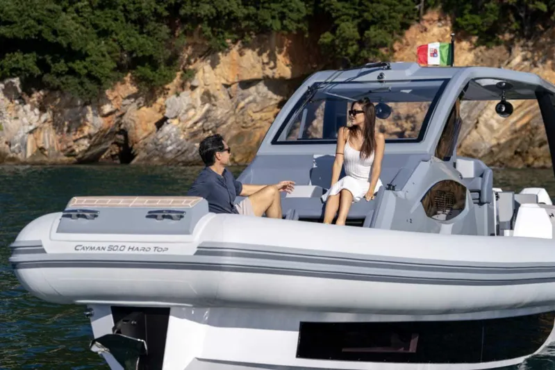  Yacht Photos Pics 2026 Ranieri CAYMAN 50 HARDTOP yacht with two people enjoying a sunny day.