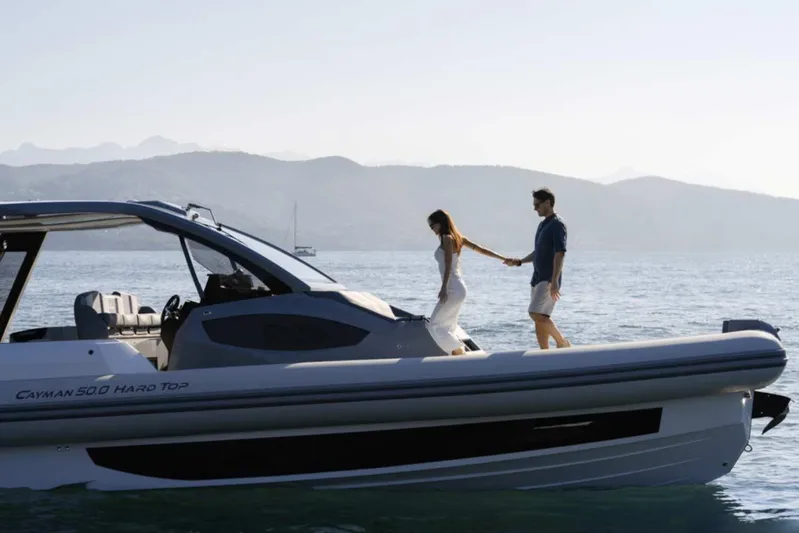  Yacht Photos Pics Couple on 2026 Ranieri CAYMAN 50 HARDTOP yacht, enjoying a serene sea view.
