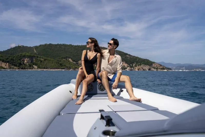  Yacht Photos Pics Couple relaxing on 2026 Ranieri CAYMAN 50 HARDTOP boat, scenic coastal backdrop.