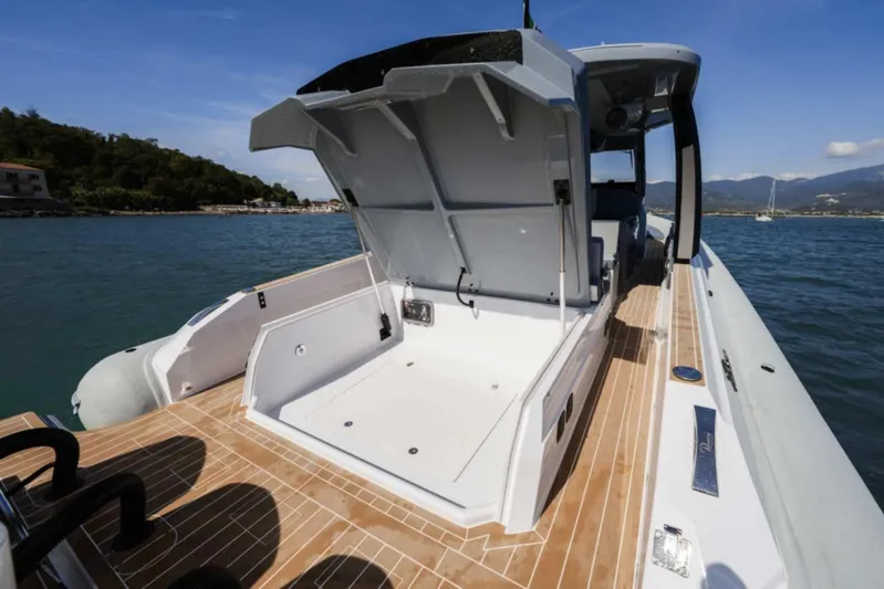  Yacht Photos Pics 2026 Ranieri CAYMAN 50 HARDTOP yacht with open deck storage, docked on calm waters.