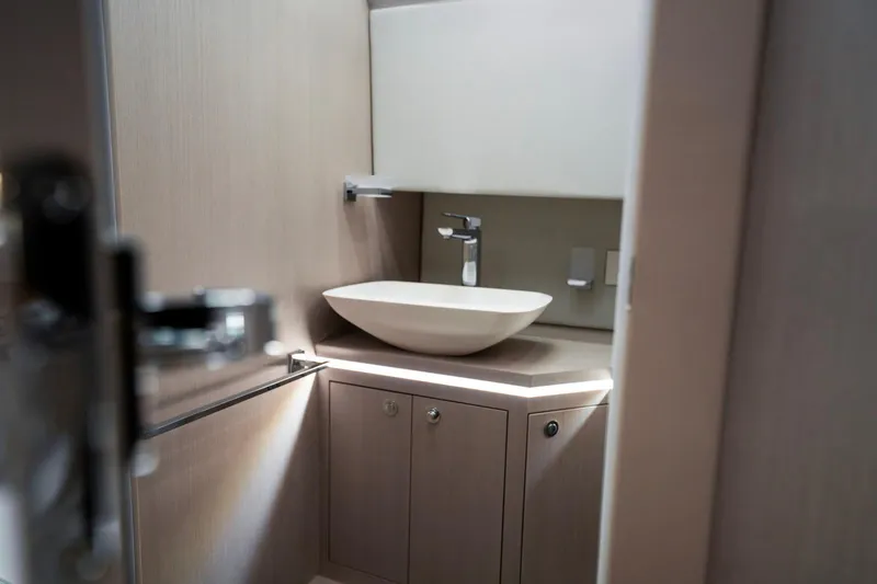  Yacht Photos Pics Modern bathroom interior on 2026 Ranieri CAYMAN 50 HARDTOP yacht, featuring sleek sink design.