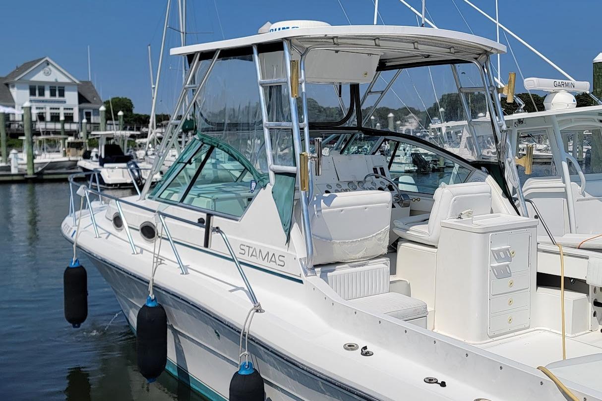 2000 Stamas 310 Express boat docked at marina, featuring sleek design and spacious cockpit.