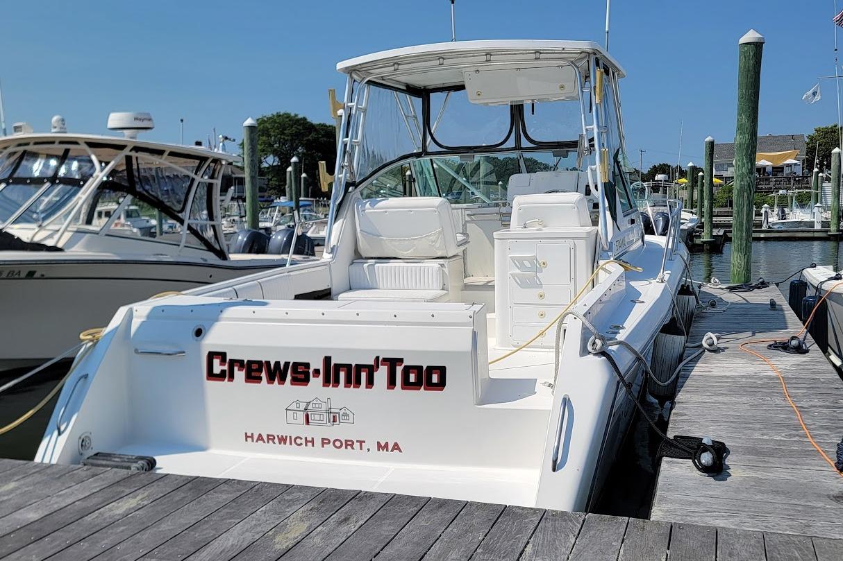 2000 Stamas 310 Express boat docked at Harwich Port, MA marina.